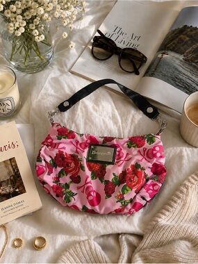 Rare Betseyville hobo bag features a vibrant skull and red rose print